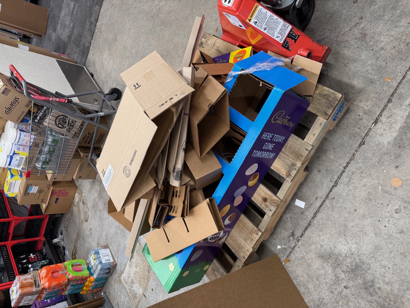 Organized cardboard and yard waste on pallet for removal