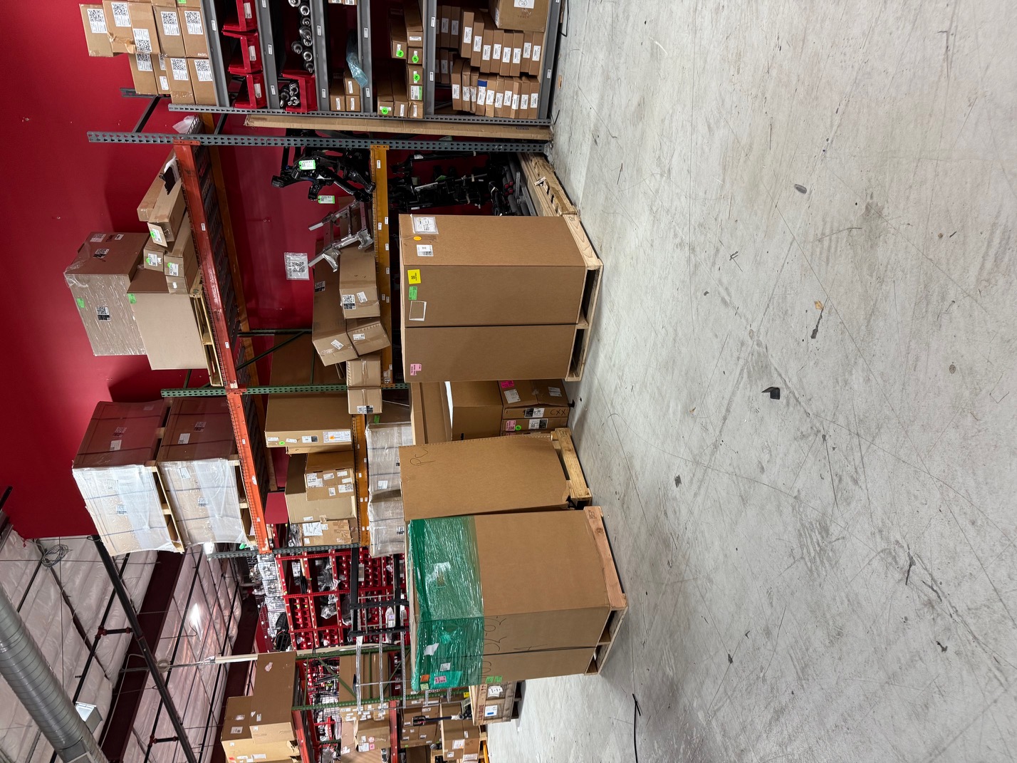 Warehouse with organized pallets and inventory before cleanup